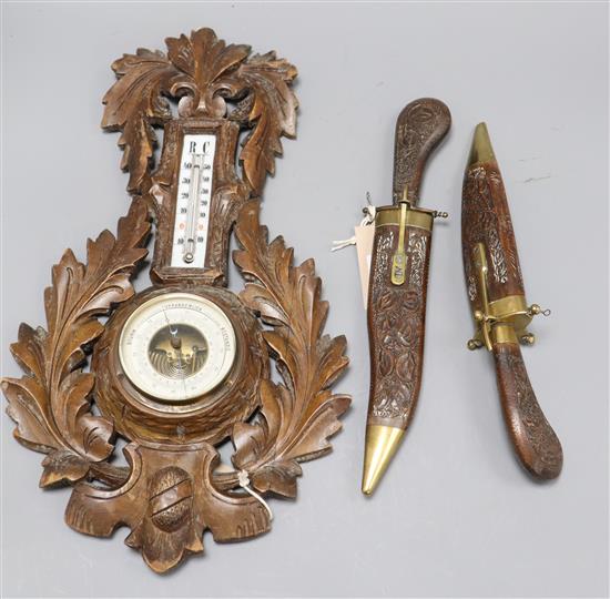 A wood and brass-mounted dagger two-piece carving set and a wall barometer/thermometer in carved wood surround